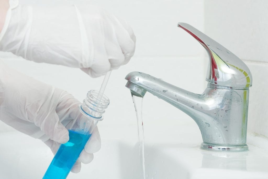 Biological Water Testing with Blue Sample Near Faucet