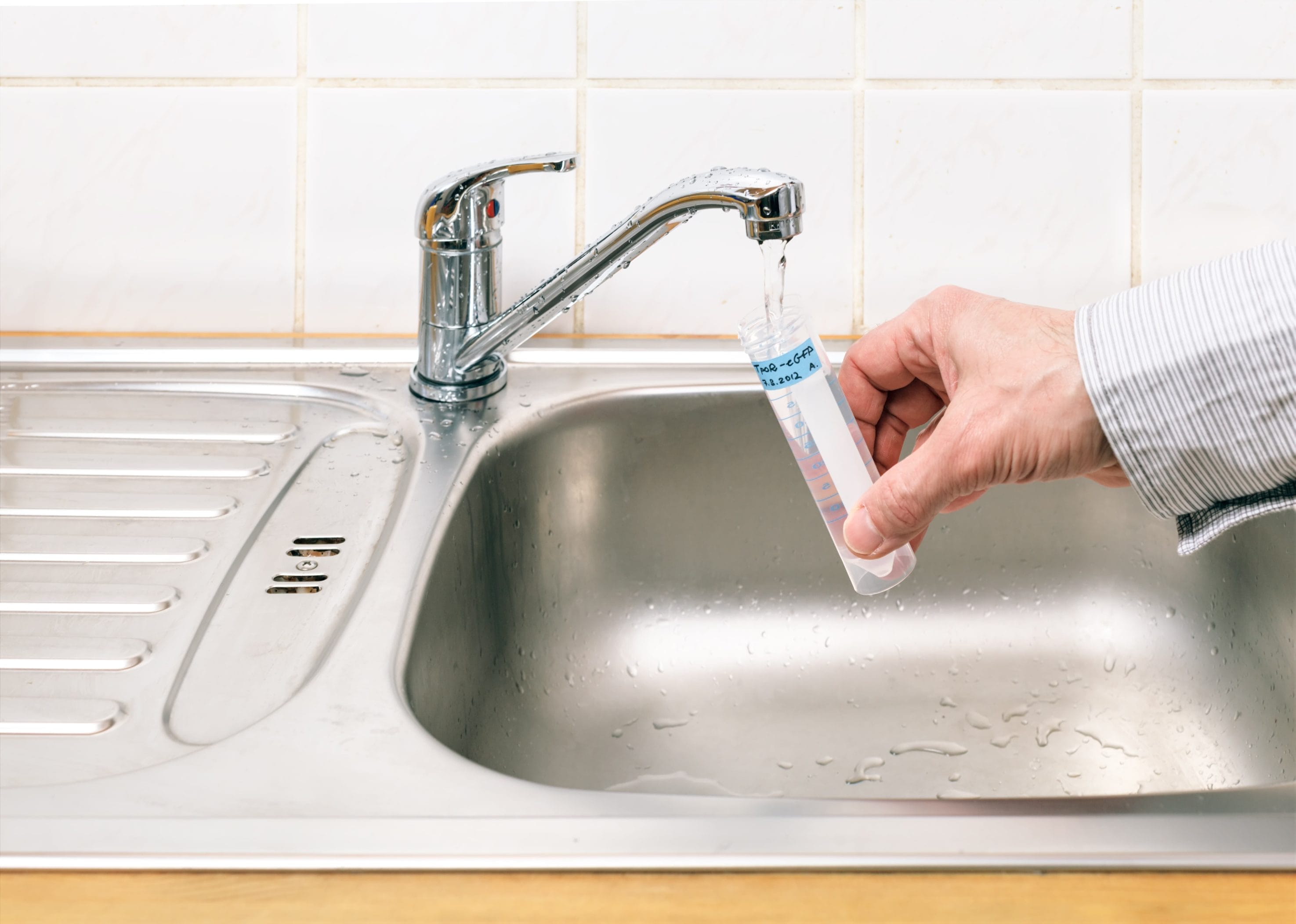 Technician conducting biological water testing to improve drinking water.