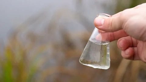 Hand Holding Flask for Vanadium Water Testing