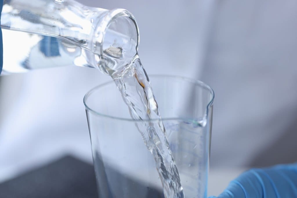 Pouring Water into Glass for Mercury Water Testing