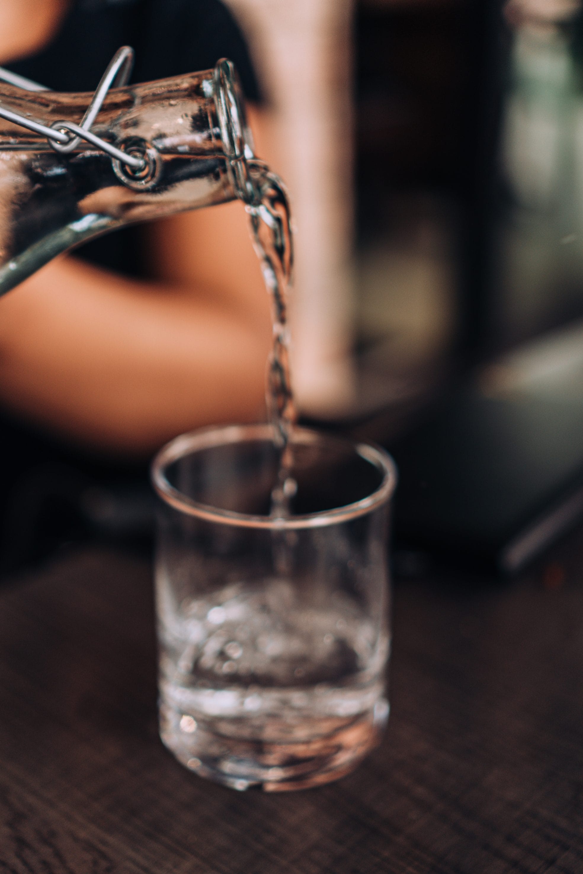 Pouring drinking water safe from vanadium into a glass
